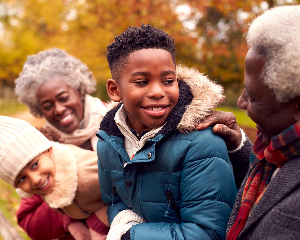 grandparents with their grandchildren at the park guaranteed income for retirement