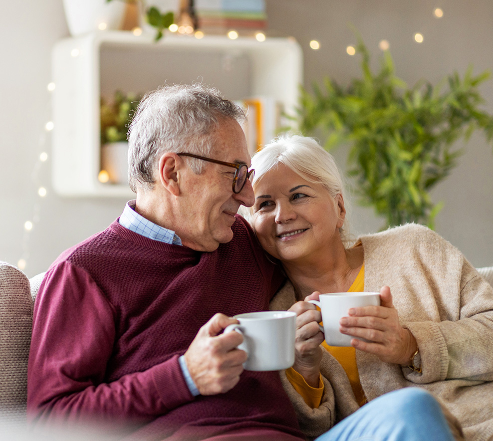 seniors cozy on couch sipping mugs fixed indexed annuity dotson financial michigan