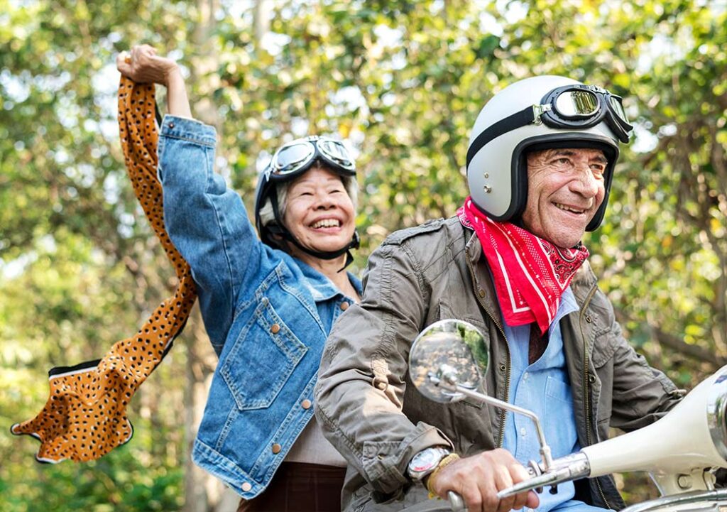 smiling senior couple riding motorcyle will I have enough to retire