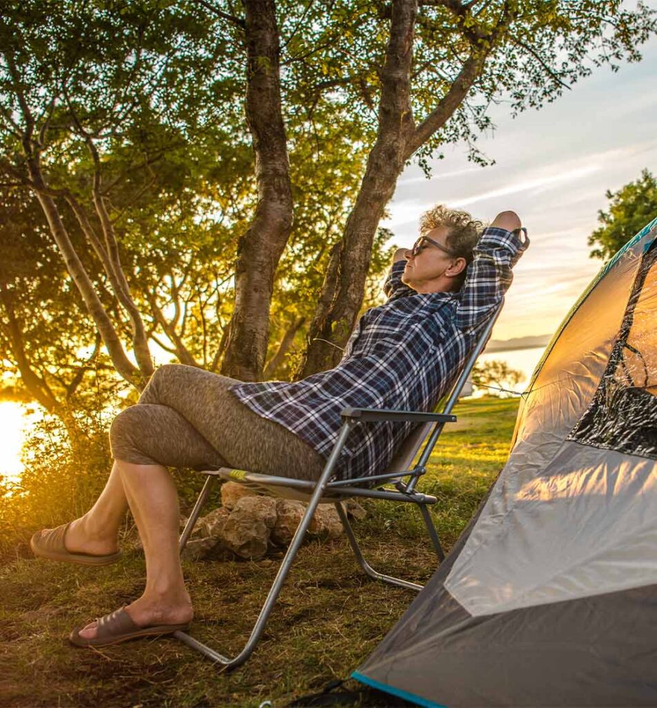 woman relaxing by her tent while camping retirement annuities